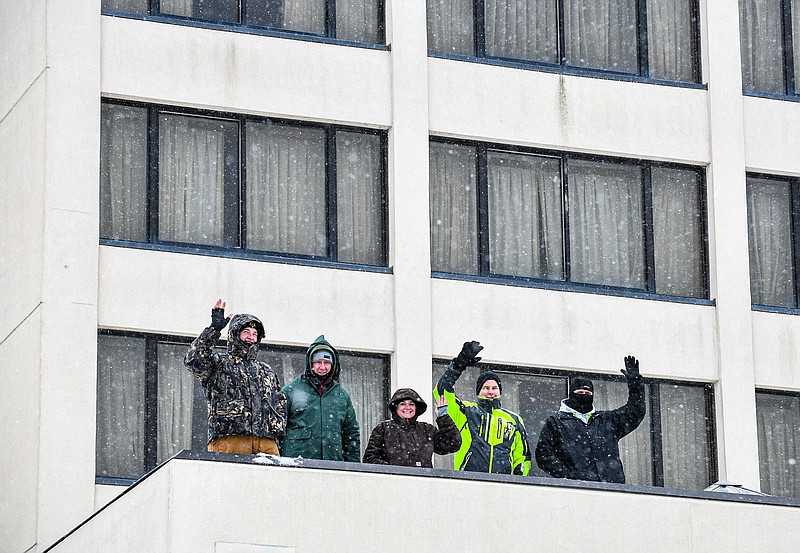 These members of law enforcement are spending 30 hours on the roof over the swimming pool at Capitol Plaza Hotel to raise money for Special Olympics Missouri. From left are, Kyle Renick, of the Cole County Sheriff’s Depatment; Tom Schultz, formerly of Corrections; Jodi Schmutz, of Algoa Correctional Center; Adam Lueckenhoff, of the Jefferson City Police Department; and Adam Koestner, of Algoa Correctional Center. Despite the treacherous weather, they decided to continue their plans for the stay. The group withstood a barrage of sleet and snow as they waved to the Jefferson City Streets Department plow truck driver as he went through the intersection of Missouri Boulivard and West McCarty Street. Some of these participants will later take part in the annual Polar Plunge on Feb. 25-26 at Lake Ozark Public Beach. (Julie Smith/News Tribune)