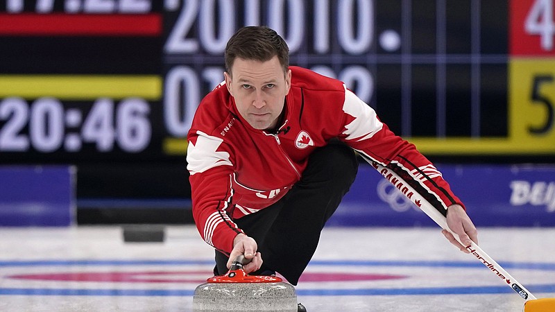 Canada's Brad Gushue throws a rock during the men's curling bronze medal match between Canada and the United States at the Beijing Winter Olympics Friday, Feb. 18, 2022, in Beijing. (AP Photo/Brynn Anderson)