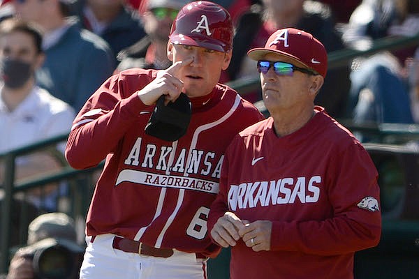 Arkansas head coach Dave Van Horn (right) talks with volunteer coach Bobby Wernes during a game against Illinois State on Saturday, Feb. 19, 2022, in Fayetteville.
