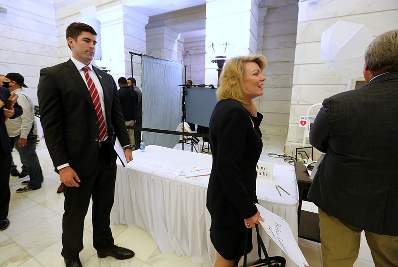 U.S. Senate candidate Jake Bequette (left) and Rep. Robin Lundstrom (right) wait to have their photo taken during the first day of candidate filing on Tuesday, Feb. 22, 2022, at the state Capitol in Little Rock. (Arkansas Democrat-Gazette/Thomas Metthe)