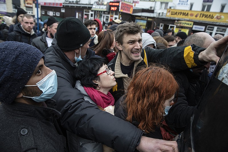 People desperately try to flee Kyiv by bus Thursday.
(For The Washington Post/Heidi Levine)