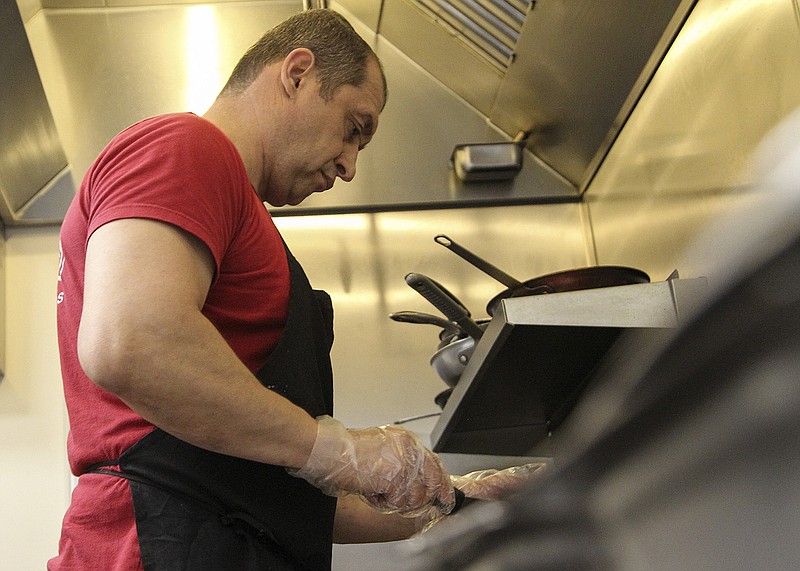 Sergey Polyakov makes crepes earlier this week at Alexa’s Creperie in Hot Springs. Polyakov, who was born in Donetsk in a region of the Soviet Union that became part of eastern Ukraine, said divisions have long simmered in Ukraine. “If you drive into West, they spoke in different Ukrainian language, and if you spoke in Russian they can beat your face,” he said. “The same will be with the Westerns when they come East.”
(Arkansas Democrat-Gazette/Will Langhorne)