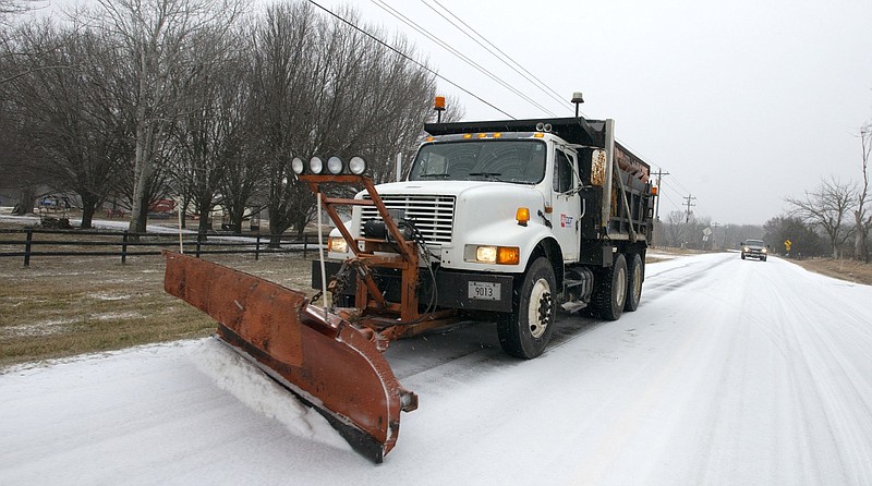 A plow from the Arkansas Department of Transportation scrapes Arkansas 265 near Hogeye on Wednesday, Feb. 23, 2022. (NWA Democrat-Gazette/J.T. Wampler) CORRECTION: This photo shows Arkansas 265. A previous version of this caption incorrectly stated the road.