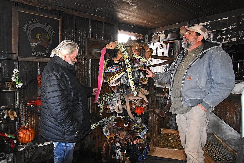 Volunteer Blake Woodson (left) and Eddie Griffin, co-owner of Cockrill’s Country Critters, look around the gift shop area Friday after a fire at the exotics barn Thursday in Austin.
(Arkansas Democrat-Gazette/Staci Vandagriff)
