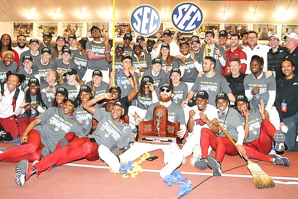 Arkansas' men's and women's track and field teams pose together after winning SEC indoor titles on Saturday, Feb. 26, 2022, in College Station, Texas.