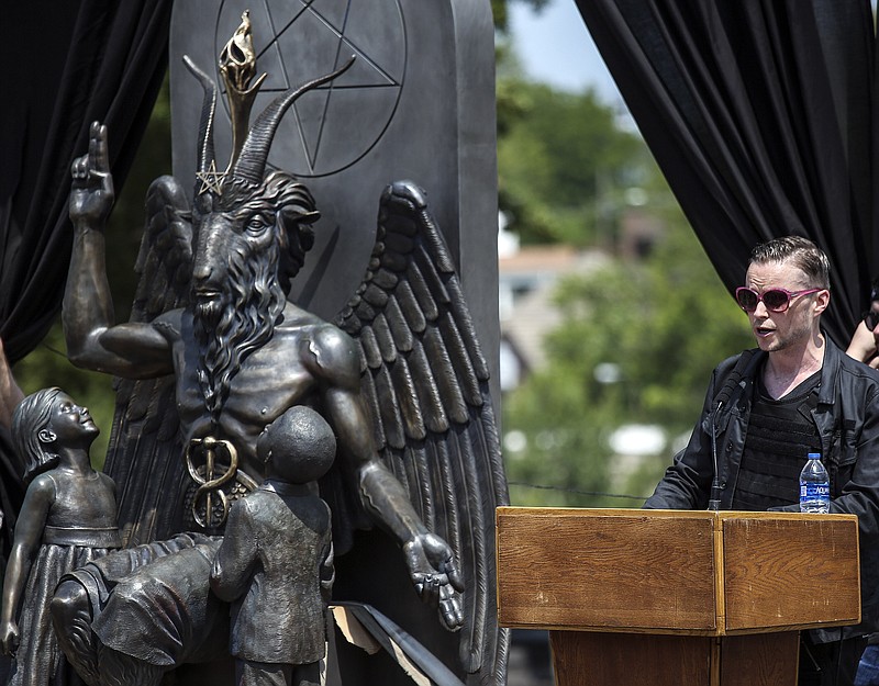FILE — Lucien Greaves, a spokesman for the New York-based Satanic Temple, speaks next to a statue of Baphomet, during the Rally for the First Amendment at the State Capitol in Little Rock Thursday, August 16, 2018. (Arkansas Democrat-Gazette/MITCHELL PE MASILUN)