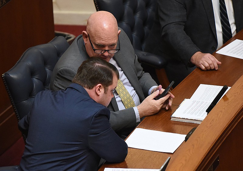 Sen. James Sturch (front), R-Batesville, confers with Sen. Mathew Pitsch, R-Fort Smith, during the Senate session Wednesday. The Senate acted on several measures as lawmakers worked toward adjourning early next week. More photos at arkansasonline.com/33ledge/.
(Arkansas Democrat-Gazette/Staci Vandagriff)