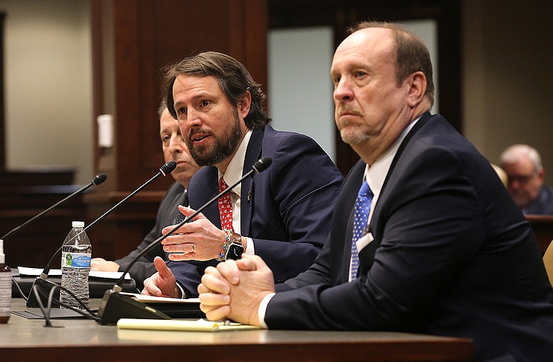 Sen. Clarke Tucker (center) addresses the Joint Budget Committee on Thursday about his bills on public defenders and deputy prosecuting attorneys. With Tucker are Bob McMahan (left), state prosecutor coordinator, and Greg Parrish (right), executive director for the Arkansas Public Defender Commission.
(Arkansas Democrat-Gazette/Thomas Metthe)