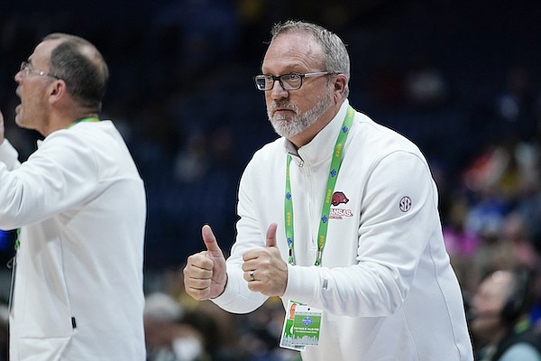 Arkansas head coach Mike Neighbors, right, watches from the sideline in the first half of an NCAA college basketball game against Missouri at the women's Southeastern Conference tournament Thursday, March 3, 2022, in Nashville, Tenn. (AP Photo/Mark Humphrey)