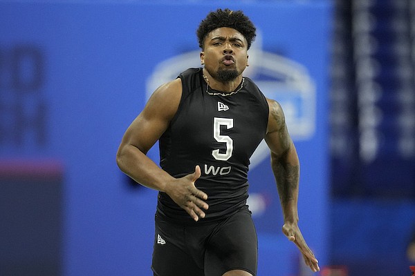 Arkansas wide receiver Treylon Burks runs the 40-yard dash at the NFL football scouting combine, Thursday, March 3, 2022, in Indianapolis. (AP Photo/Charlie Neibergall)