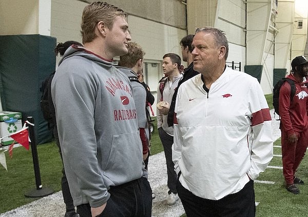 Arkansas football coach Sam Pittman (right) speaks with linebacker Bumper Pool during the Razorbacks' Pro Day on Wednesday, March 9, 2022, in Fayetteville.
