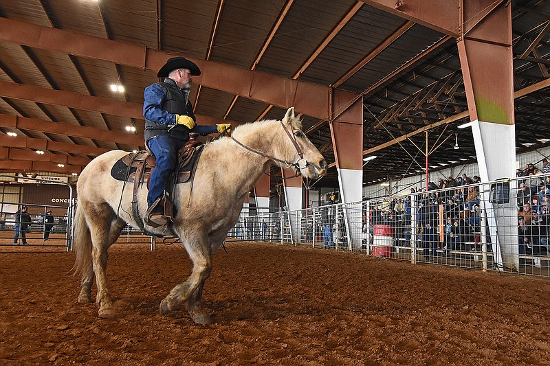 Lt. Heath Johnson rides Custer, a yellow gelding from the East Arkansas Regional Unit, around the pen Saturday during the Arkansas Department of Corrections Horse Auction at the Saline County Fairgrounds.
(Arkansas Democrat-Gazette/Staci Vandagriff)