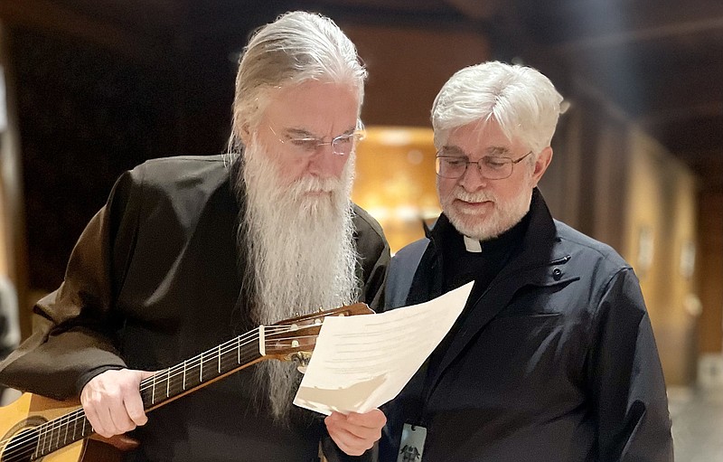 Christian recording artist John Michael Talbot of Berryville (left) consults with Father John Marconi, pastor of Our Lady of the Holy Souls Catholic Church in Little Rock, shortly before playing music Tuesday evening for Marconi’s congregation. Talbot, a Grammy-winning performer, has held concerts at Catholic parishes around Central Arkansas this week.
(Arkansas Democrat-Gazette/Frank E. Lockwood)