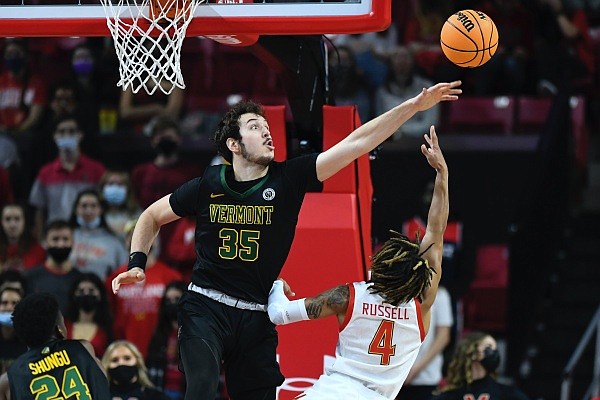 Maryland guard Fatts Russell has his shot blocked by Vermont forward Ryan Davis during the first half of an NCAA college basketball game, Saturday, Nov. 13, 2021, in College Park, Md. (AP Photo/Terrance Williams)