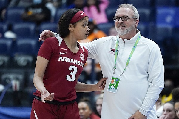 Arkansas head coach Mike Neighbors talks with Elauna Eaton (3) in the second half of an NCAA college basketball game against South Carolina at the women's Southeastern Conference tournament Friday, March 4, 2022, in Nashville, Tenn. (AP Photo/Mark Humphrey)
