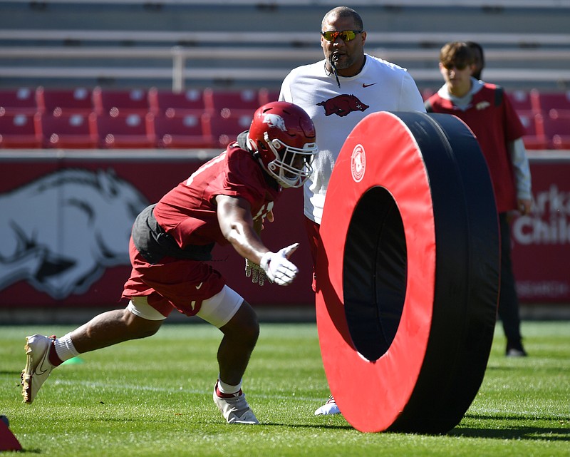 Arkansas defensive line coach Deke Adams directs his players Tuesday, March 15, 2022, during practice at Razorback Stadium in Fayetteville. Visit nwaonline.com/220316Daily/ for today's photo gallery..(NWA Democrat-Gazette/Andy Shupe)