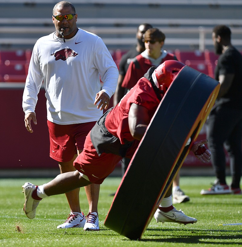 Arkansas defensive line coach Deke Adams directs his players Tuesday, March 15, 2022, during practice at Razorback Stadium in Fayetteville. Visit nwaonline.com/220316Daily/ for today's photo gallery..(NWA Democrat-Gazette/Andy Shupe)