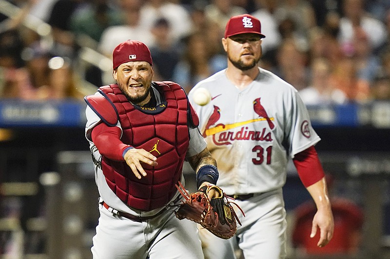 St. Louis Cardinals catcher Yadier Molina walks to the dugout after  accepting his Rawlings Gold Glove and Platinum Glove awards for his  defensive skills during the 2015 season before a game against