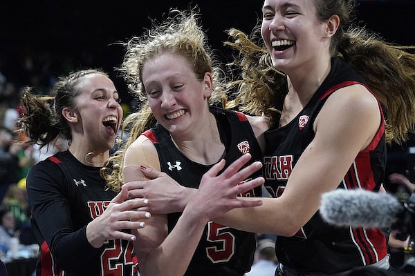 From left, Utah's Kennady McQueen (24), Gianna Kneepkens (5) and Jenna Johnson (22) celebrate after defeating Oregon in an NCAA college basketball game in the semifinal round of the Pac-12 women's tournament Friday, March 4, 2022, in Las Vegas. (AP Photo/John Locher)