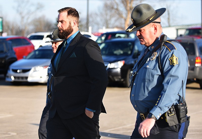 State troopers escort Michael Davis to court Thursday in Cabot for the third day of Davis’ trial. The jury began deliberations later in the day, with the option to convict Davis of negligent homicide if they don’t find him guilty of manslaughter.
(Arkansas Democrat-Gazette/Staci Vandagriff)