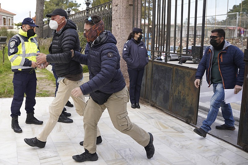 A police officer escorts Norwegian photographer Knut Bry to court Friday in the Aegean island of Lesbos, Greece. The 75-year-old photographer has been arrested on the Greek island on espionage-related charges.
(AP/Panagiotis Balaskas)