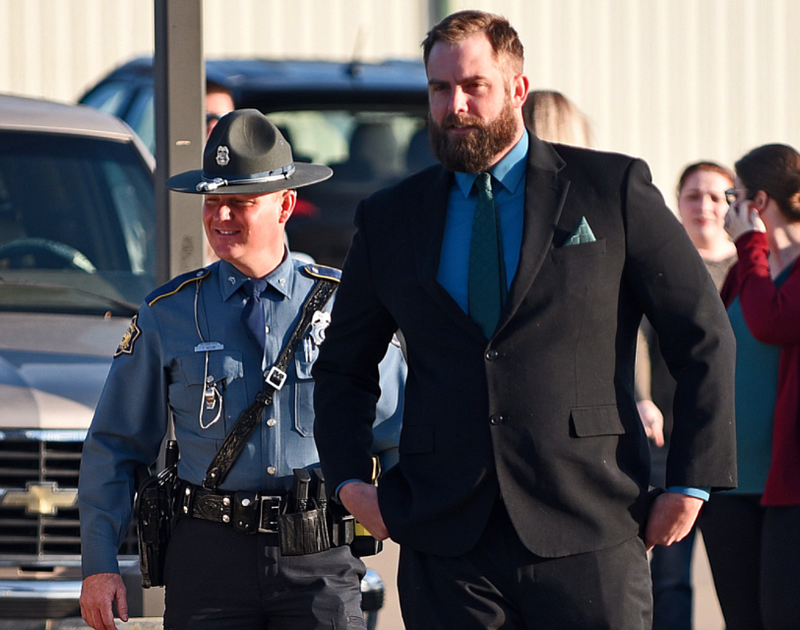 Arkansas State Troopers escort former Lonoke County sheriff's deputy Michael Davis on Thursday at the Cabot Readiness Center. (Arkansas Democrat-Gazette/Staci Vandagriff)