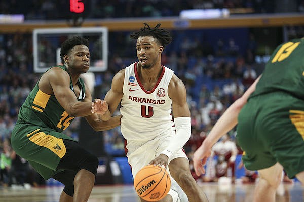 Arkansas' Stanley Umude (0) drives the ball past a Vermont defender during an NCAA Tournament game on Thursday, March 17, 2022, in Buffalo, N.Y.