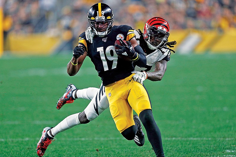 In this Sept. 30, 2019, file photo, Steelers wide receiver JuJu Smith-Schuster runs with the ball after a catch during a game against the Bengals. (Associated Press)