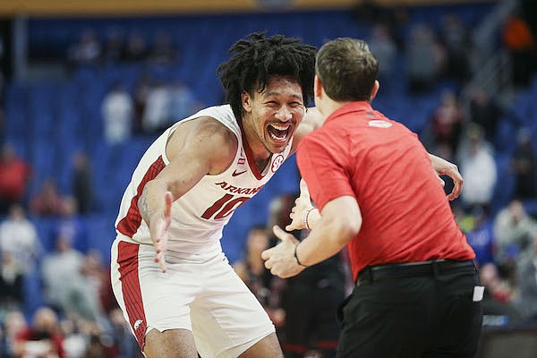 Arkansas forward Jaylin Williams (10) celebrates with coach Eric Musselman near the end of the Razorbacks' 53-48 win over New Mexico State on Saturday, March 19, 2022, at the NCAA Tournament in Buffalo, N.Y. Arkansas forward Jaylin Williams (10) celebrates with coach Eric Musselman near the end of the Razorbacks' 53-48 win over New Mexico State on Saturday, March 19, 2022, at the NCAA Tournament in Buffalo, N.Y.