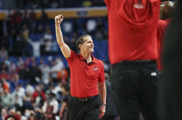 Arkansas coach Eric Musselman celebrates near the end of a 53-48 victory over New Mexico State at the NCAA Tournament on Saturday, March 19, 2022, in Buffalo, N.Y.