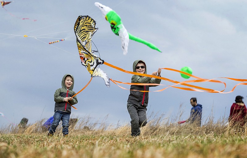 Children launch their tiger kite during the annual Eureka Springs Kite Festival hosted by Turpentine Creek Wildlife Refuge in Eureka Springs. (NWA Democrat-Gazette file photo/Ben Goff)