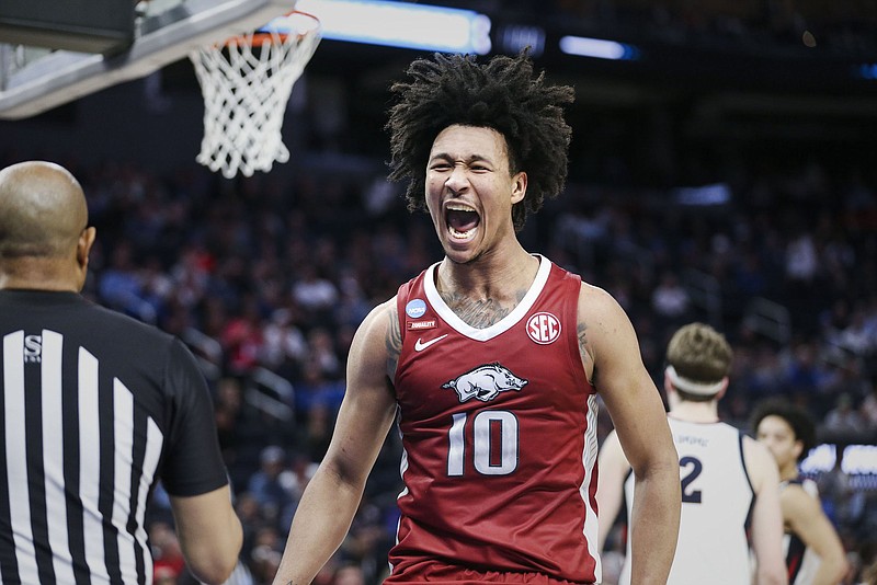 Arkansas forward Jaylin Williams screams in excitement Thursday after dunking the ball during the No. 17 Razorbacks’ 74-68 victory over top-ranked Gonzaga in the West Region semifinals of the NCAA Tournament. Arkansas will face Duke at 7:50 p.m. Central on Saturday on TBS in Saturday’s regional final. More photos at arkansasonline.com/325ncaaua/.
(NWA Democrat-Gazette/Charlie Kaijo)