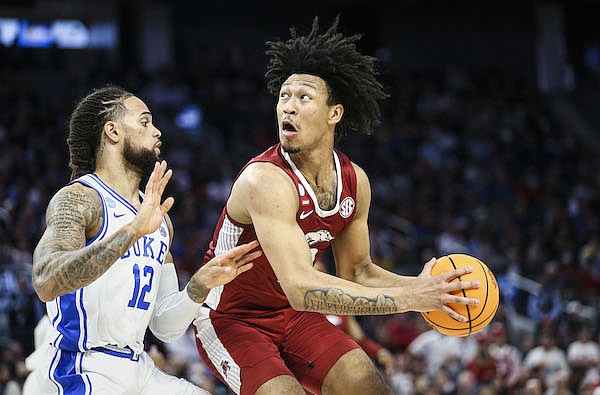 Arkansas forward Jaylin Williams (10) is guarded by Duke's Theo John (12) during an NCAA Tournament game Saturday, March 26, 2022, in San Francisco.