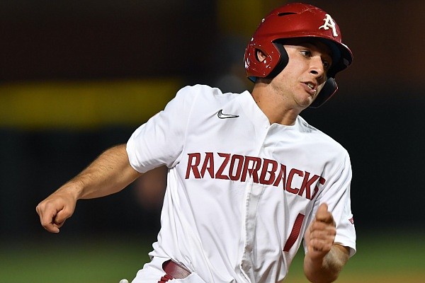 Arkansas second baseman Robert Moore heads to the plate Tuesday, March 29, 2022, on a single by left fielder Chris Lanzilli during the third inning against UALR at Baum Walker Stadium in Fayetteville. Visit nwaonline.com/220330Daily/ for the photo gallery.