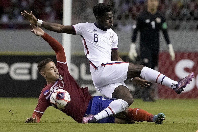 Yumus Musah (6) of the United States gets tangled up with Costa Rica’s Brandon Aguilera (bottom) as they battle for the ball Wednesday during the Americans’ 2-0 loss to Costa Rica in in San Jose, Calif. Despite the loss, the United States clinched a berth for this year’s FIFA World Cup in Qatar.
(AP/Moises Castillo)