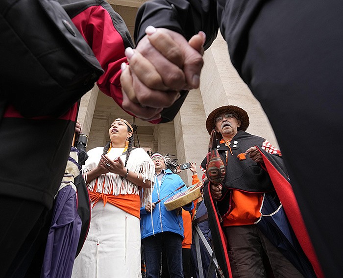 Members of the Assembly of First Nations perform a traditional song Thursday outside St. Peter’s Square at the Vatican as their delegation meets with Pope Francis over the church’s past role in Canada’s oppressive residential schools for Indigenous children. Delegates expressed optimism the pope would offer an apology in remarks today. More photos at arkansasonline.com/41nations/.
(AP/Andrew Medichini)