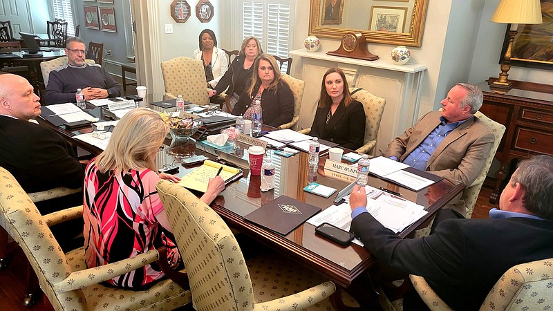 Southeast Arkansas College board members go over options to commence a $37 million to $39 million building project during a retreat Friday at the DuBocage House in Pine Bluff. 
(Pine Bluff Commercial/I.C. Murrell)