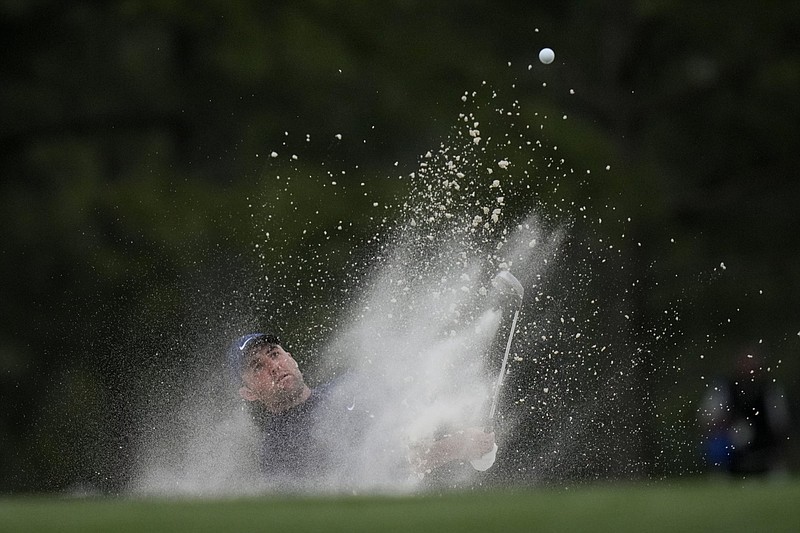 Scottie Scheffler hits out of a bunker on the 17th hole during the second round at the Masters on Friday in Augusta, Ga. Scheffler shot a 5-under 67, tying the Masters record by building a five-shot lead going into today’s third round. More photos at arkansasonline.com/49masters22/
(AP/Jae C. Hong)