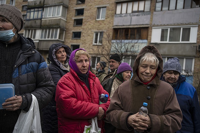 Women wait for food from a soup kitchen Saturday in war-ravaged Bucha on the outskirts of Kyiv, Ukraine.
(AP/Rodrigo Abd)