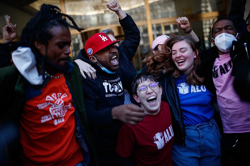 Staten Island-based Amazon.com Inc. distribution center union members celebrate after getting the voting results to unionize on April 1 in New York.
(AP/Eduardo Munoz Alvarez)