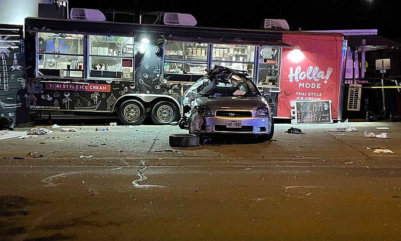 A damaged vehicle sits in front of a food truck Friday night after a wreck in Austin, Texas.
(AP/Acacia Coronado)