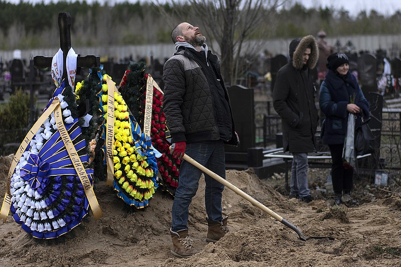 Cemetery worker Artem looks at the sky in exhaustion Wednesday while digging the grave of Andriy Verbovyi, 55, who was killed by Russian soldiers while serving in Bucha territorial defense on the outskirts of Kyiv, Ukraine. More photos at arkansasonline.com/ukrainemonth2/.
(AP/Rodrigo Abd)