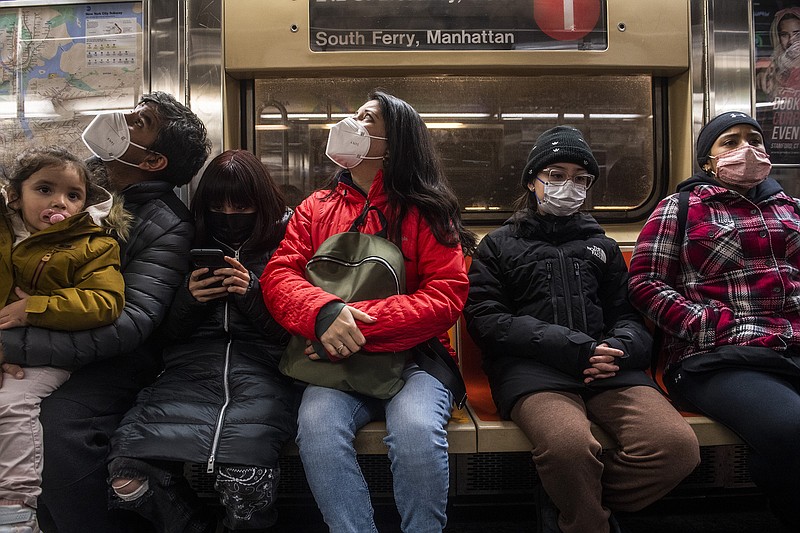 People wear masks as required while riding the subway in New York in February. The nationwide mask requirement for public transit and air travel, set to expire next week, is being extended for 15 days as U.S. virus cases show a rebound.
(The New York Times/Brittainy Newman)