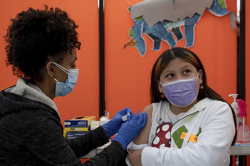 Samantha Castaned, 10, gets her first dose of the Pfizer vaccine in San Francisco in November. Company officials said Thursday that children age 5 to 11 show increased levels of antibodies to fight the coronavirus with a booster injection of the Pfizer-BioNTech vaccine.
(The New York Times/Mike Kai Chen)