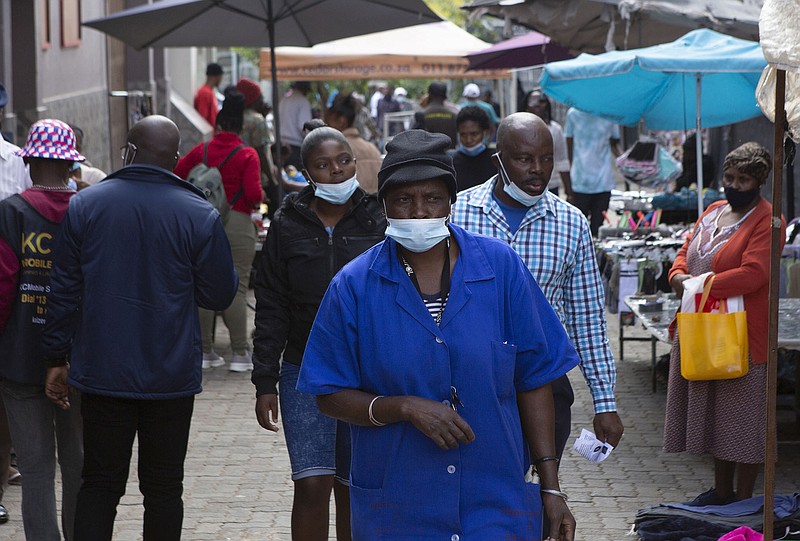 People walk through the busy Bara Taxi Rank in Soweto, South Africa, on Tuesday. Despite past warnings that covid-19 would devastate Africa, the continent has been one of the least affected by the virus.
(AP/Thandiwe Garusa)