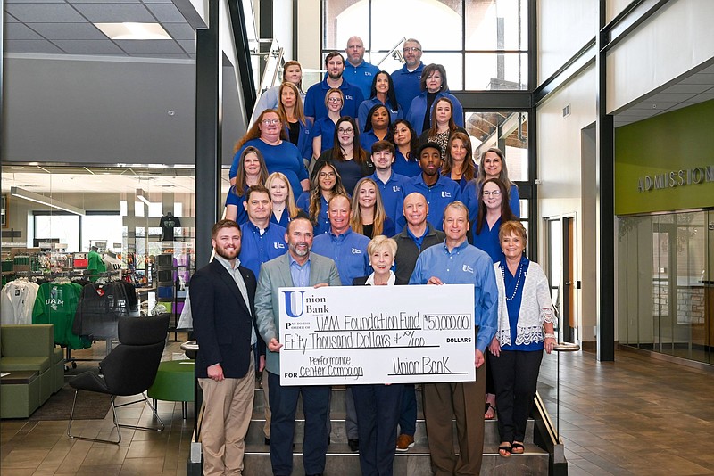 UAM Chancellor Peggy Doss (center, front row) and other officials display a $50,000 check from Union Bank & Trust Co. 
(Special to The Commercial/University of Arkansas at Monticello)