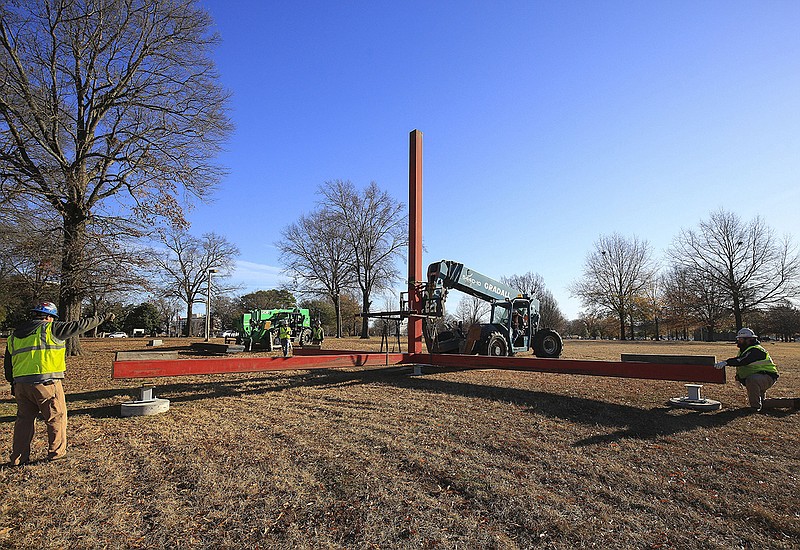 Workers from Nabholz Construction lower “Standing Red” into its new spot in Little Rock’s MacArthur Park on Dec. 4, 2019. The sculpture, commissioned in 1970 in honor of former Arkansas first lady Jeannette Rockefeller, was being relocated because of the Arkansas Museum of Fine Arts project. Now, the minimalist artwork has been dismantled.
(Arkansas Democrat-Gazette/Staton Breidenthal)