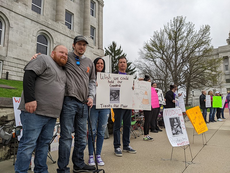 From left, Russell Dabbs, Michael Brown, and David and Tina Jarvis protest Friday outside the Missouri Department of Transportation building on Capitol Avenue. Brown is a MoDOT employee who was struck by a truck and permanently injured while working on a roadway last November in St. Louis . The same incident killed Kaitlyn Anderson and her unborn child, who would've been the Jarvis' grandson. (Ryan Pivoney/News Tribune)