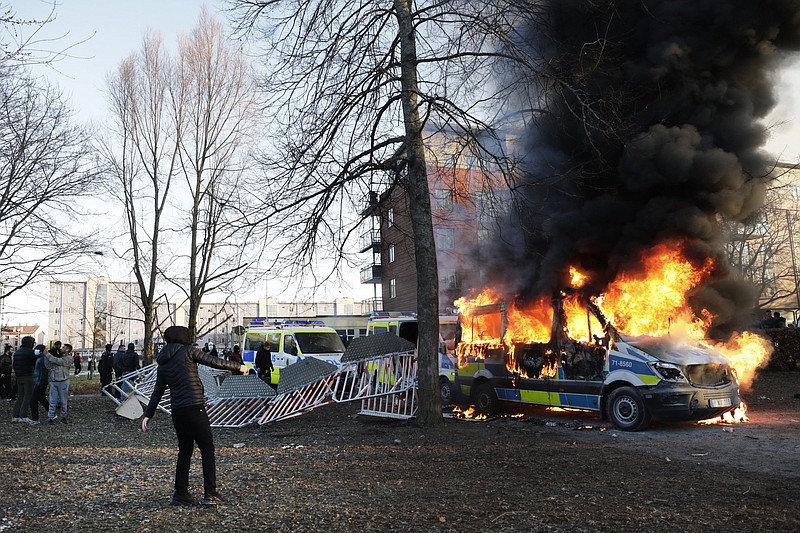 Protesters set fire to a police bus Friday in Orebro, Sweden.
(AP/TT/Kicki Nilsson)
