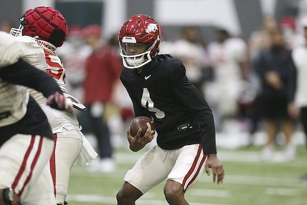 Arkansas quarterback Malik Hornbsy (4) carries the ball during a scrimmage Saturday, April 16, 2022, in Fayetteville.